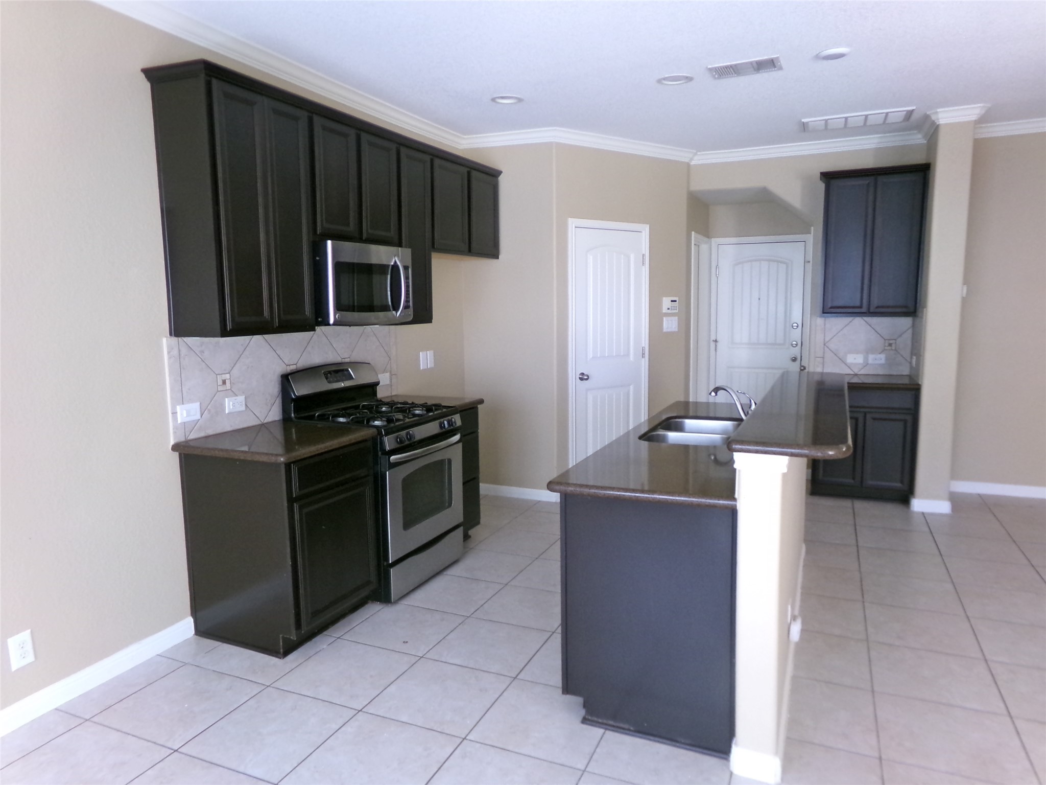 14001 Avery Ranch Boulevard, Unit 2103 Austin, TX 78717 - Photo 5 of 21 Kitchen featuring appliances with stainless steel finishes, backsplash, and crown molding,