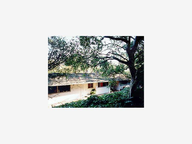 a picture of a bench in front of a house