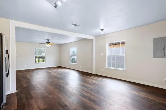 wooden floor in an empty room with a window