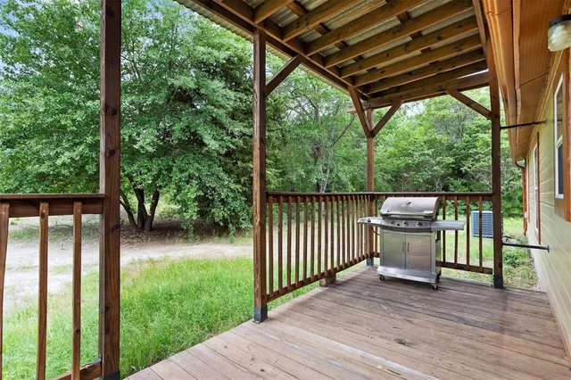 a view of a backyard with wooden floor and outdoor seating