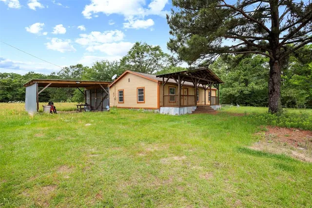 a view of a house with a yard porch and sitting area