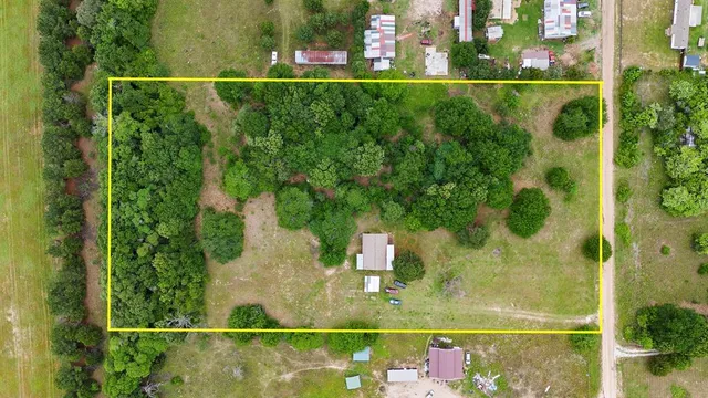 an aerial view of residential houses with outdoor space and lake view