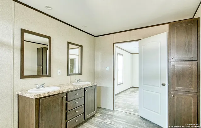 a bathroom with a granite countertop sink mirror and double