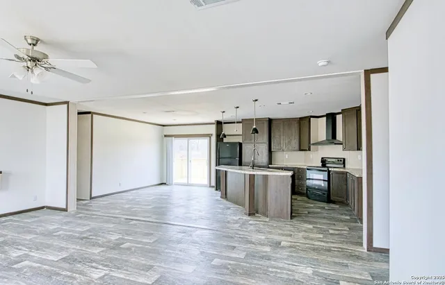 a view of a kitchen with a stove cabinets and wooden floor