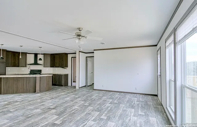 a view of a kitchen with a sink and a window