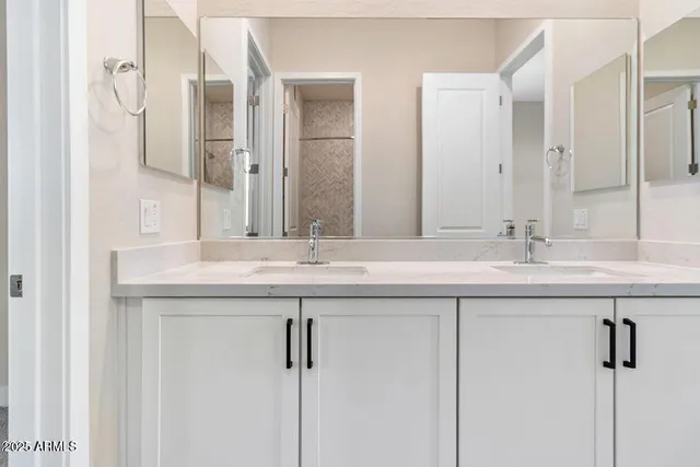 a bathroom with a sink double vanity and a mirror
