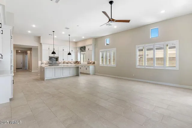 a large windows in a room with a large window and stainless steel appliances