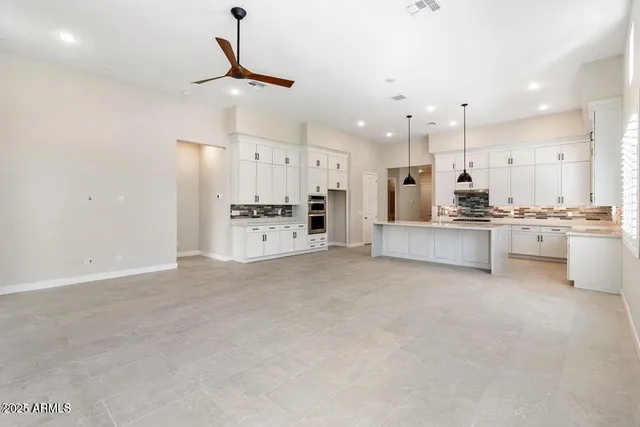 a large kitchen with cabinets and stainless steel appliances