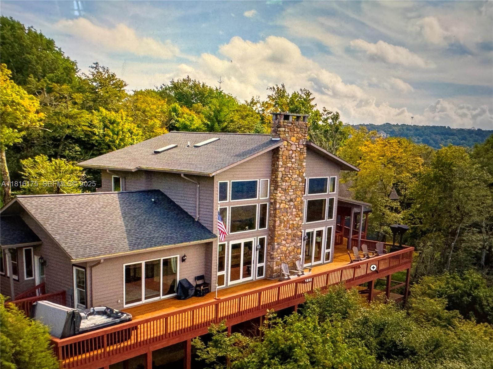 a aerial view of a house with a yard and balcony