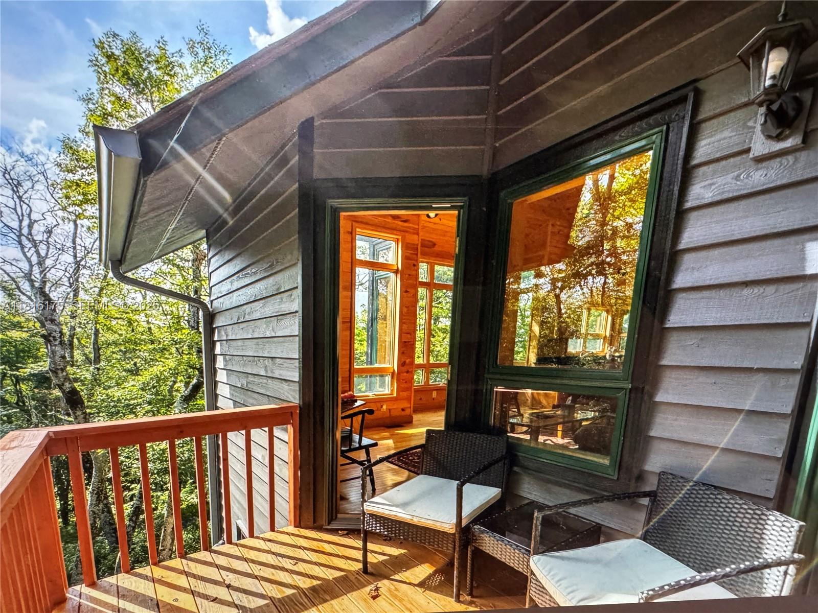 200 Summit Lodge Road Banner Elk, NC 28604 - Photo 36 of 51 a porch with a bench next to a yard