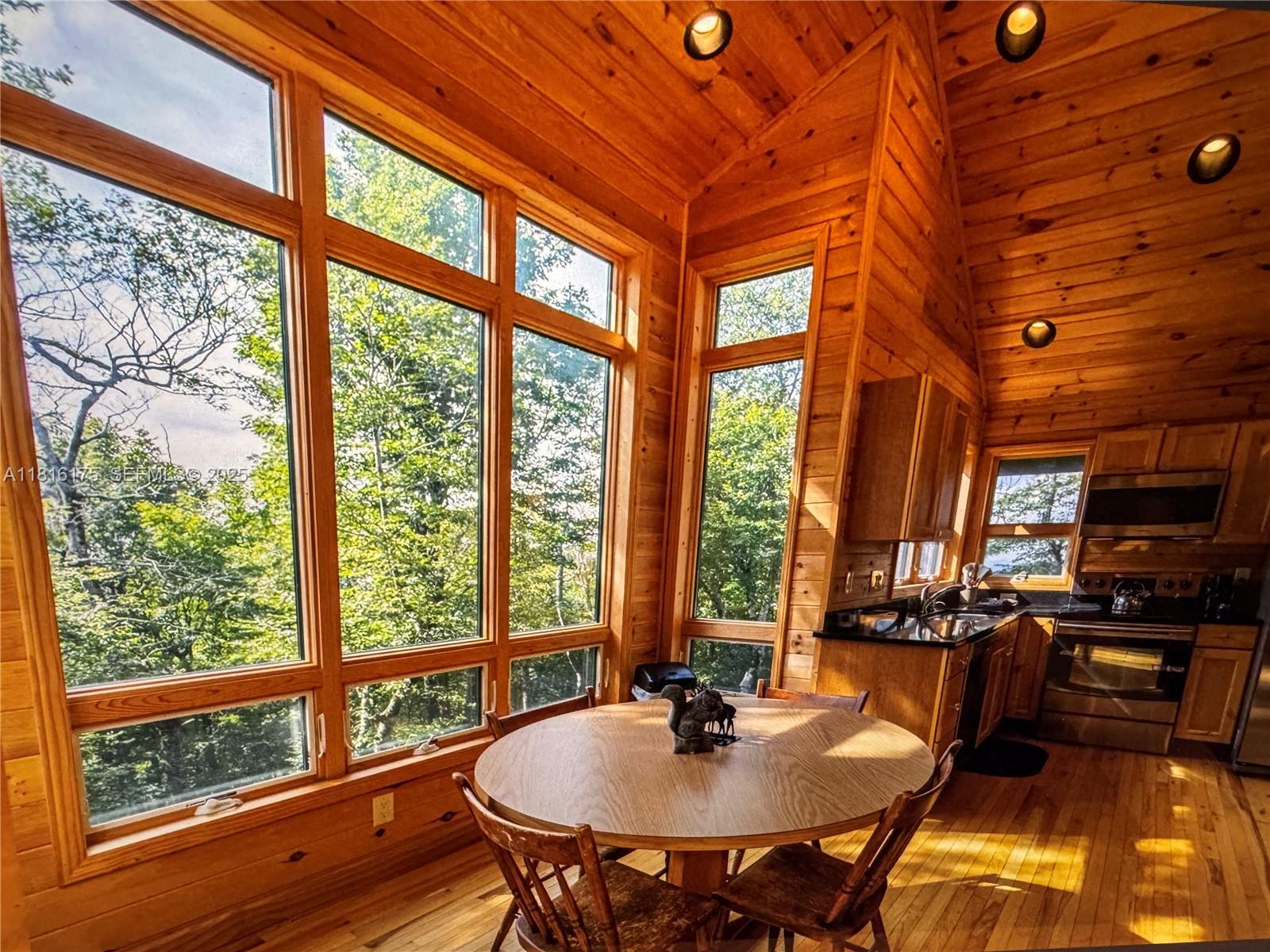 200 Summit Lodge Road Banner Elk, NC 28604 - Photo 39 of 51 a dining room with furniture and a floor to ceiling window