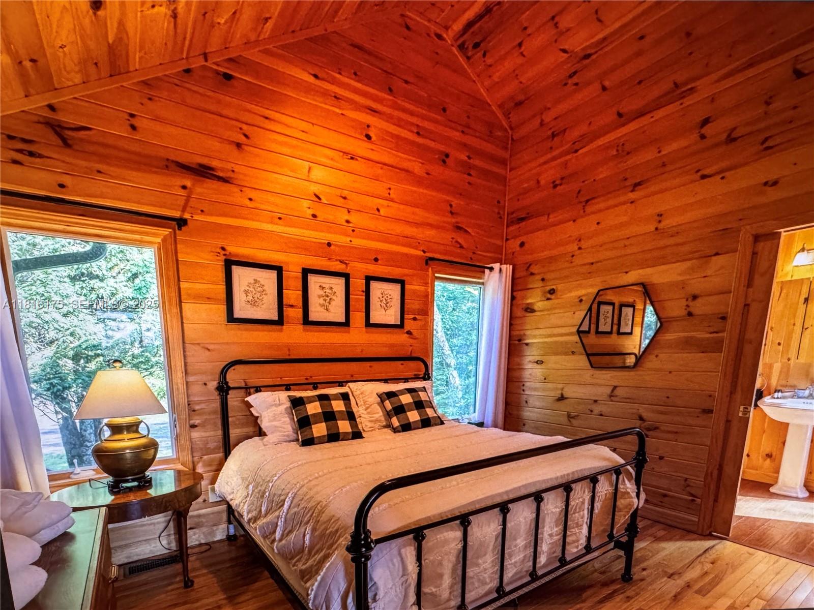 200 Summit Lodge Road Banner Elk, NC 28604 - Photo 41 of 51 a bedroom with a bed next to a window with outer view