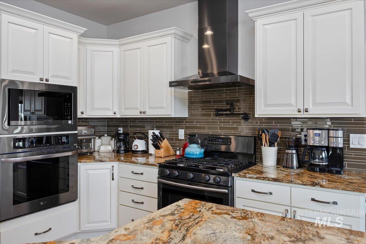40 Bell Rapids Road Hagerman, ID 83332 - Photo 9 of 50 Kitchen with white cabinetry, stainless steel appliances, and light stone counters