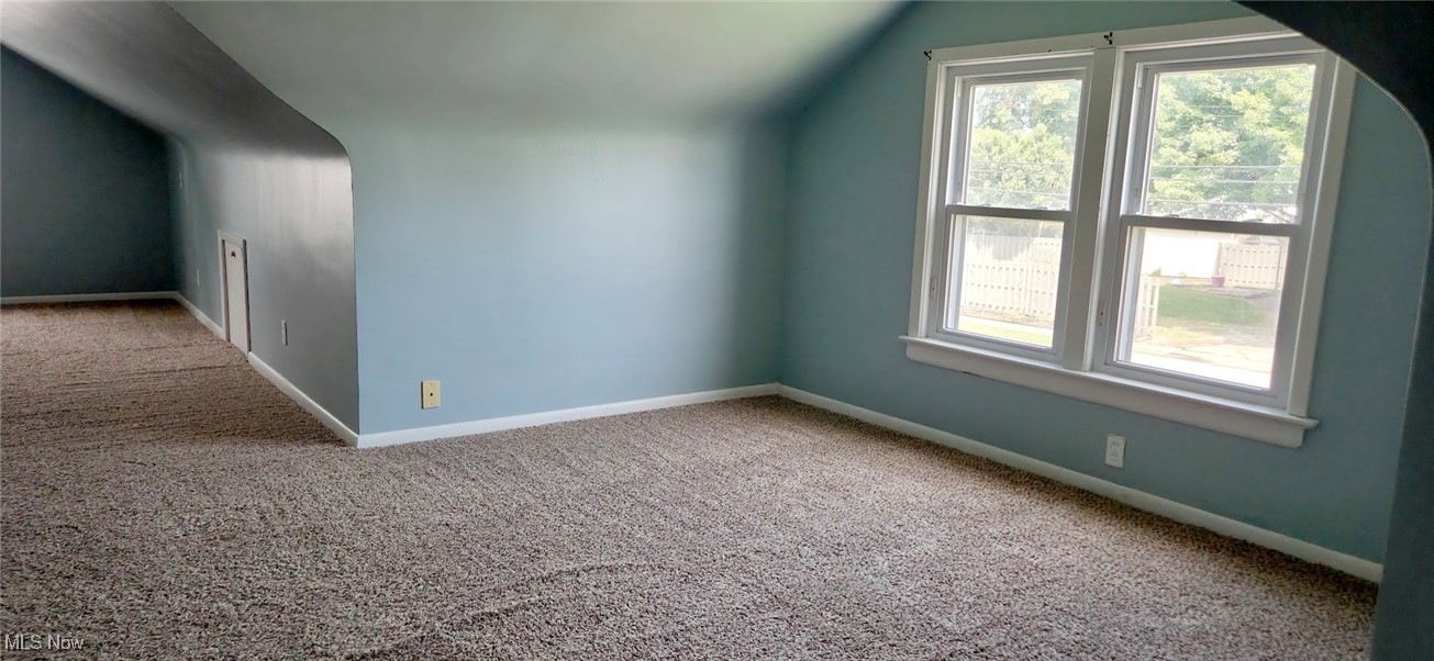 30616 Clarmont Road Willowick, OH 44095 - Photo 16 of 17 Additional living space featuring carpet floors, healthy amount of natural light, and vaulted ceiling