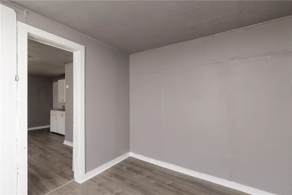 a view of a room with wooden floor