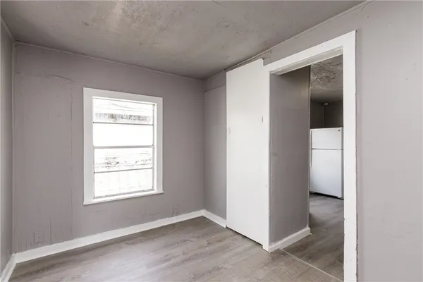an empty room with windows and closet