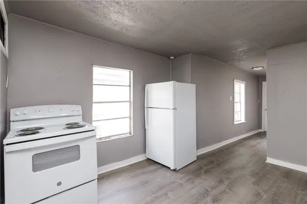 a kitchen with a stove and a refrigerator