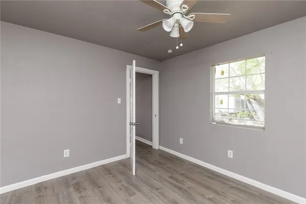 wooden floor in an empty room with a window