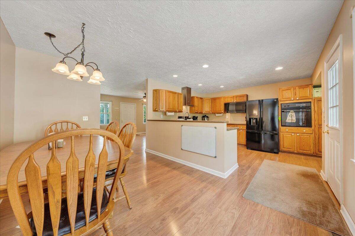 30 Highland Lake Road Union Hall, VA 24176 - Photo 9 of 51 a kitchen with stainless steel appliances kitchen island granite countertop a table chairs and a refrigerator
