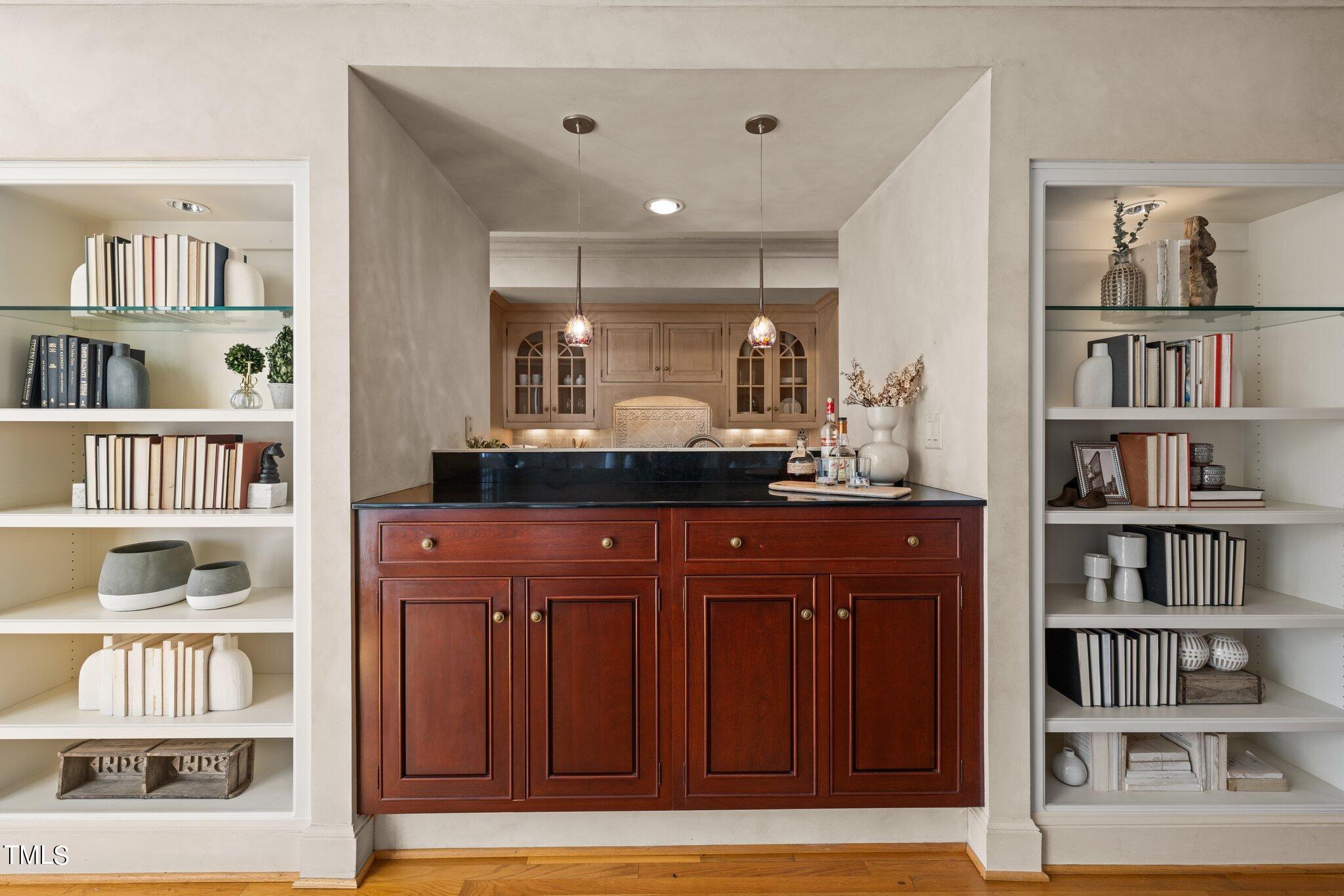 202 Villa Drive Durham, NC 27712 - Photo 24 of 53 a kitchen with cabinets and a book shelf