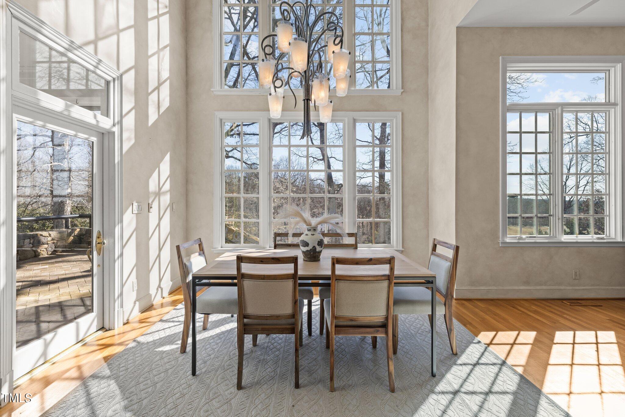 202 Villa Drive Durham, NC 27712 - Photo 25 of 53 a view of a dining room with furniture wooden floor and a chandelier