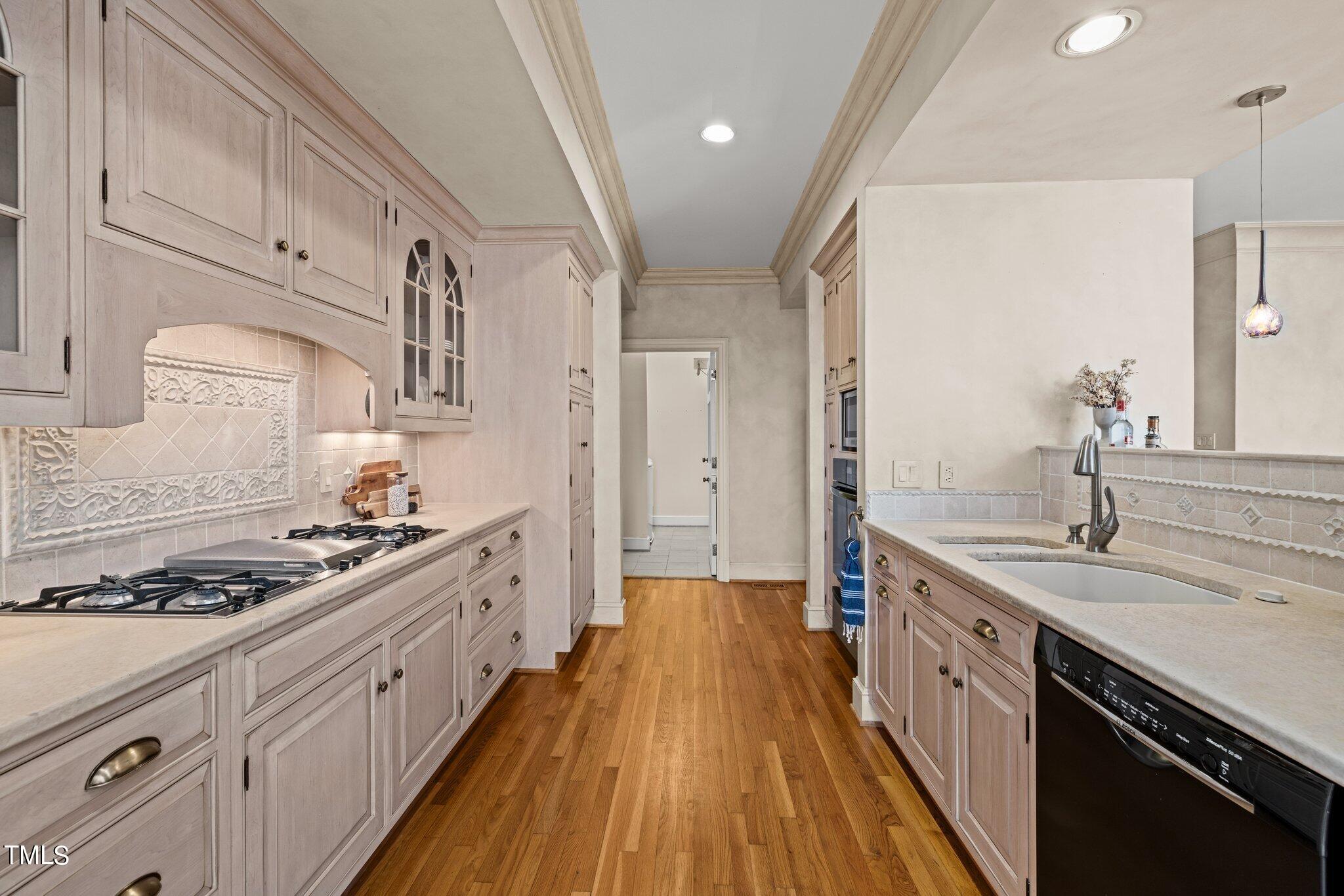 202 Villa Drive Durham, NC 27712 - Photo 28 of 53 a large kitchen with stainless steel appliances granite countertop a lot of counter space and wooden floors