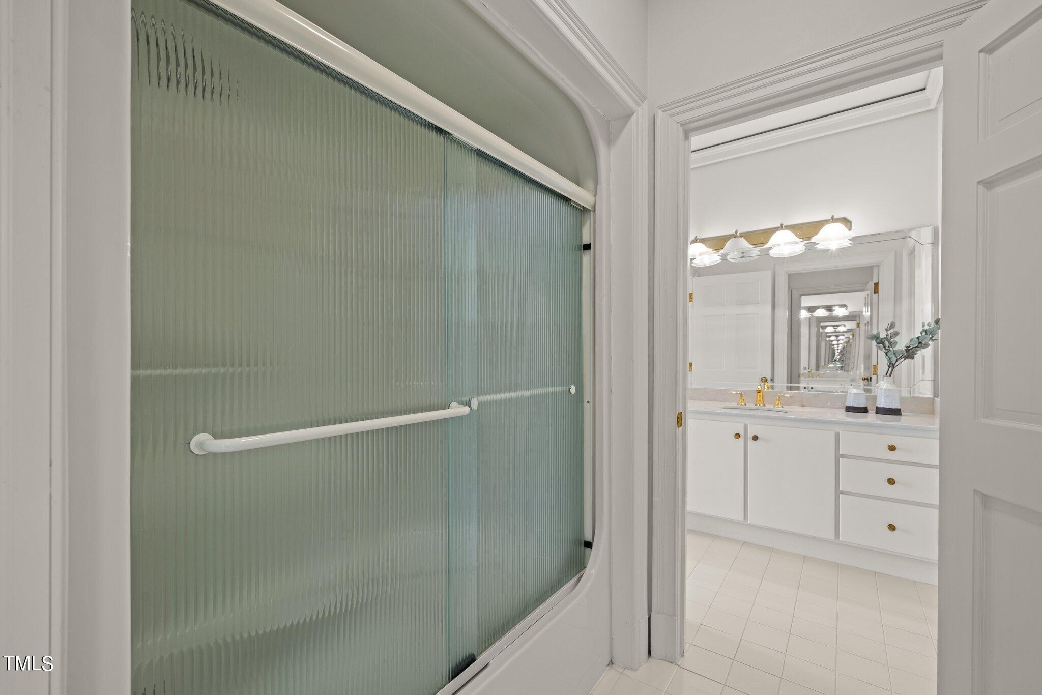 202 Villa Drive Durham, NC 27712 - Photo 37 of 53 a bathroom with a shower sink and mirror