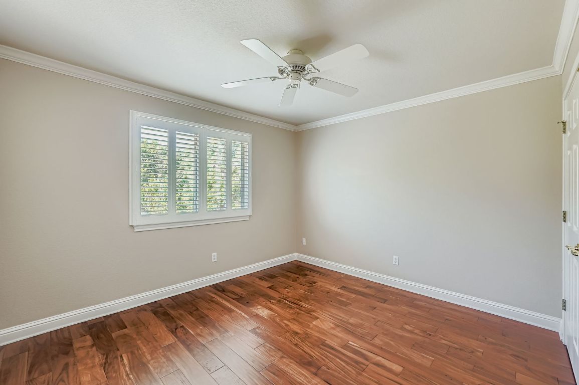 5000 Mission Oaks Boulevard, Unit 61 Austin, TX 78735 - Photo 20 of 27 Spare room with crown molding, wood-type flooring, and ceiling fan