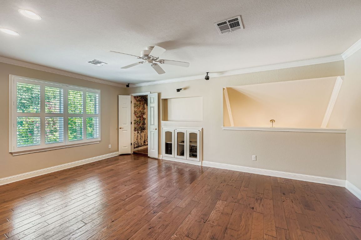 5000 Mission Oaks Boulevard, Unit 61 Austin, TX 78735 - Photo 21 of 27 Upstairs living room with ornamental molding, hardwood / wood-style floors, and a ceiling fan