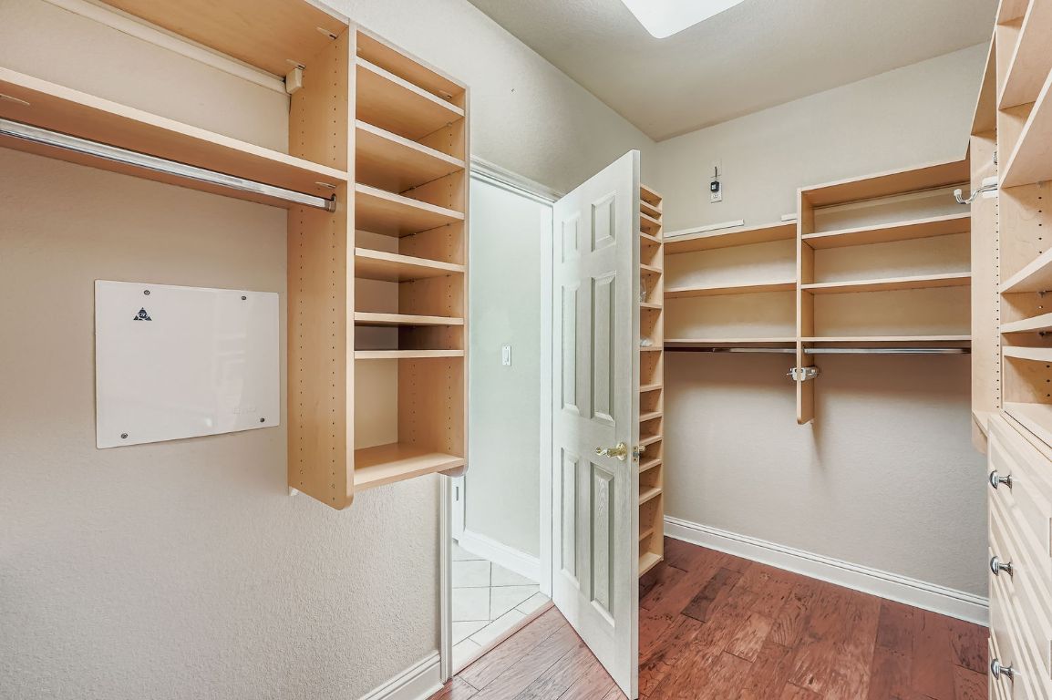 5000 Mission Oaks Boulevard, Unit 61 Austin, TX 78735 - Photo 24 of 27 Primary Walk in closet featuring wood finished floors