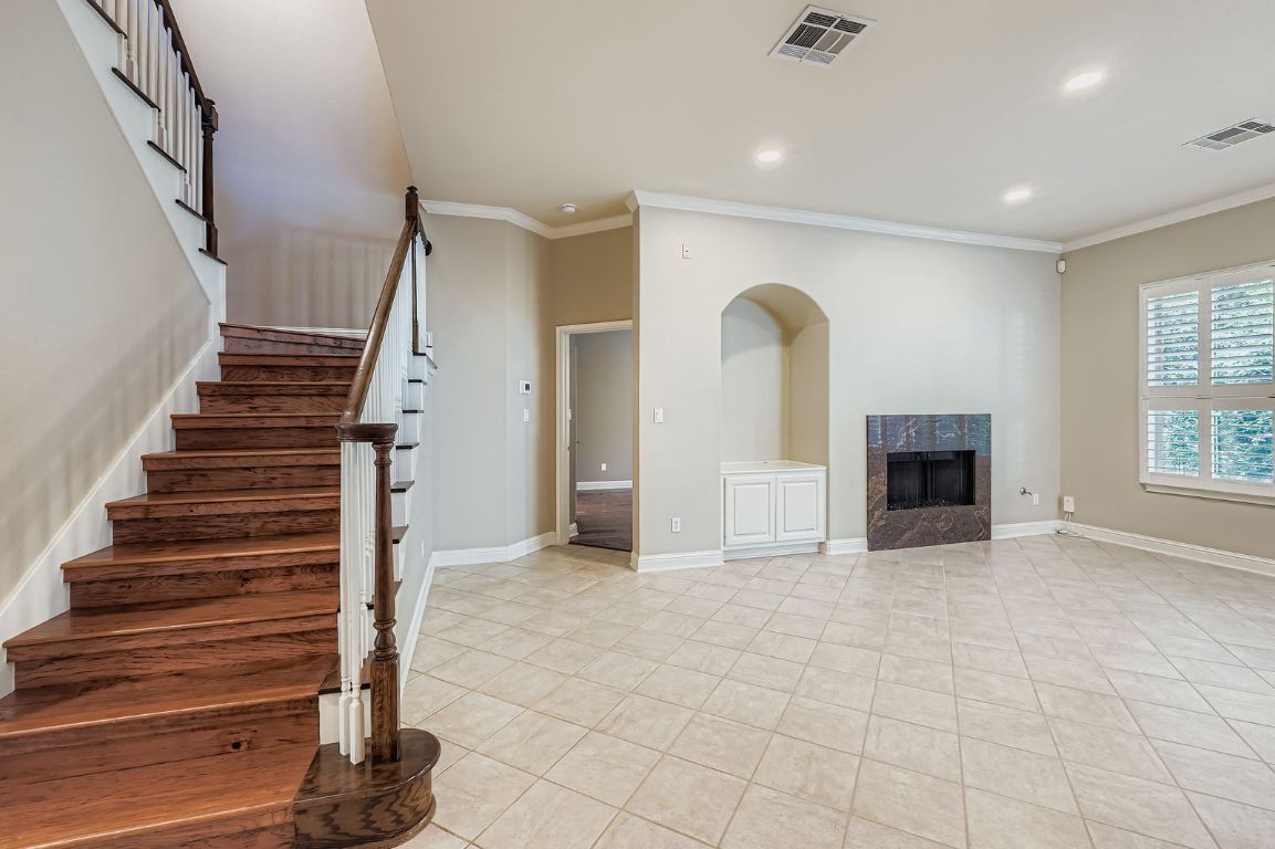 5000 Mission Oaks Boulevard, Unit 61 Austin, TX 78735 - Photo 4 of 27 Stairway with ornamental molding, tile patterned floors, a fireplace, and recessed lighting