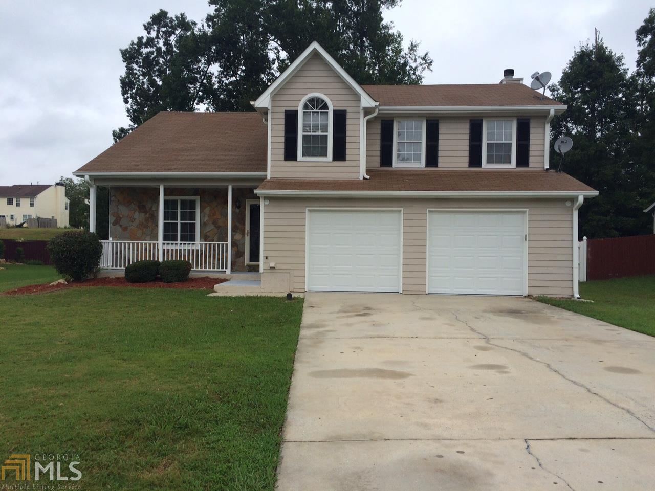 1318 Misty Ridge Court Hampton, GA 30228 - Photo 1 of 1 a front view of a house with a garden