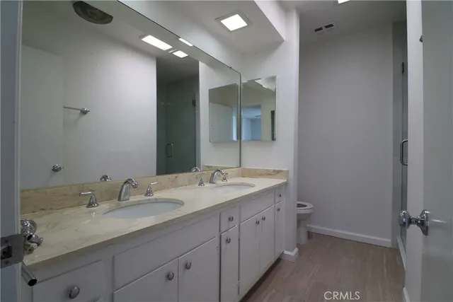 a bathroom with a granite countertop sink double and mirror