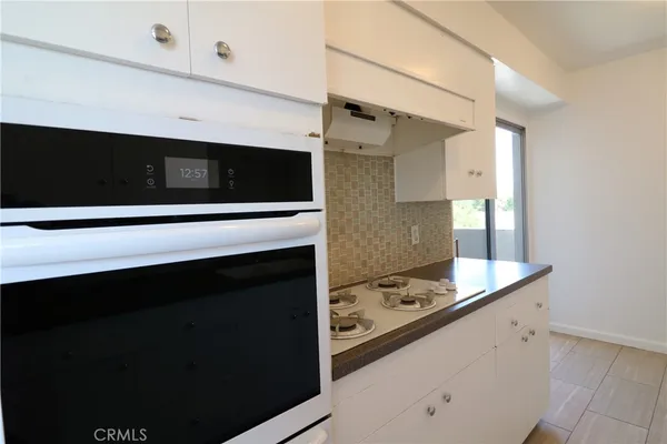 a kitchen with a stove and a microwave