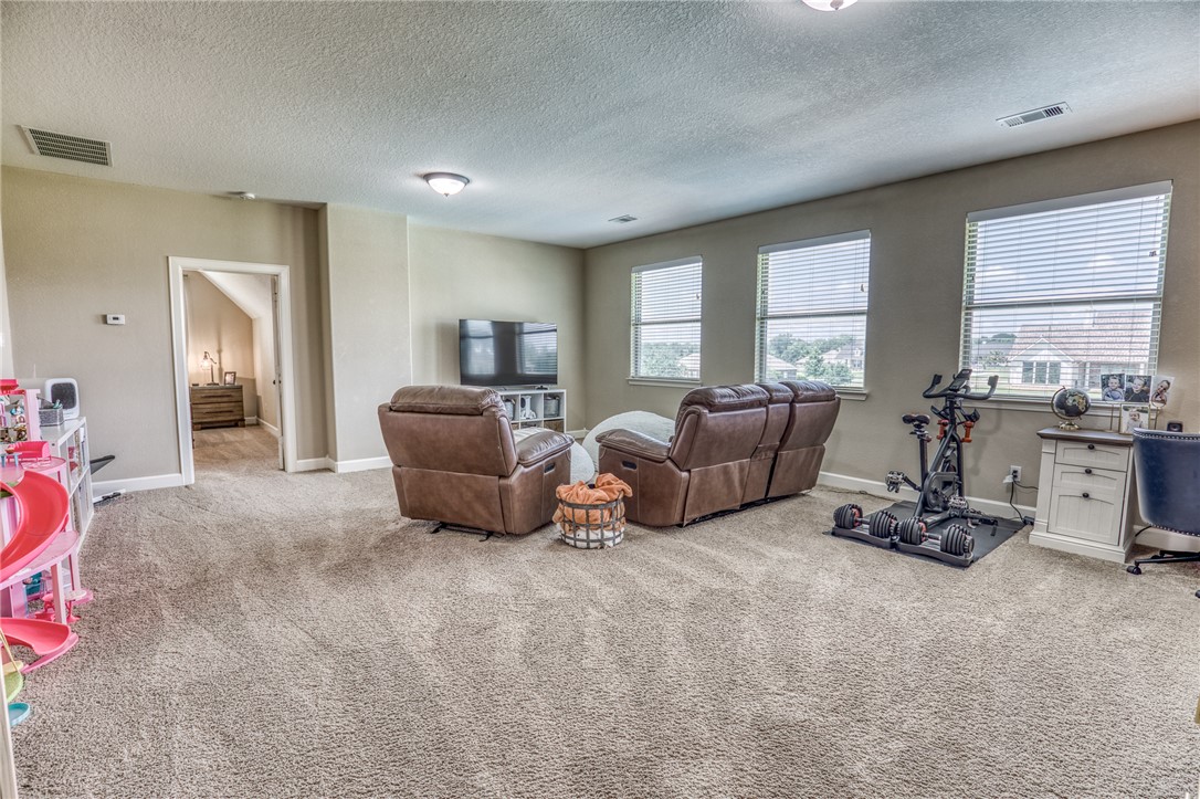586 Ruby Drive Bellville, TX 77418 - Photo 21 of 50 a living room with furniture a window and a flat screen tv