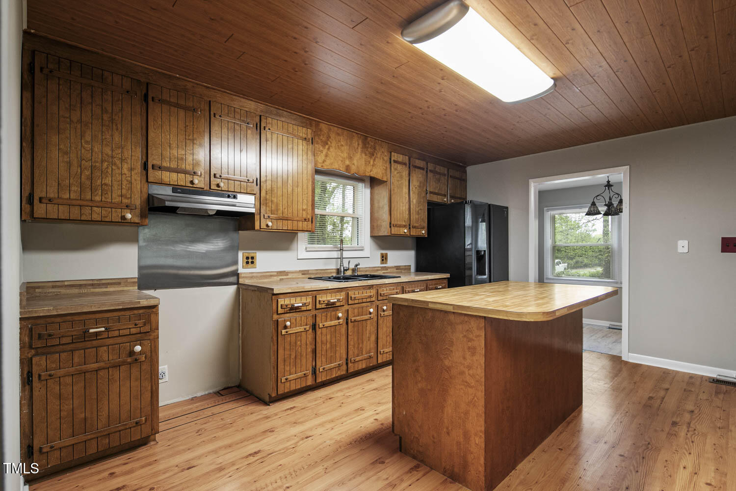 952 Glover Road Dunn, NC 28334 - Photo 11 of 31 a kitchen with stainless steel appliances granite countertop wooden floors and wooden cabinets