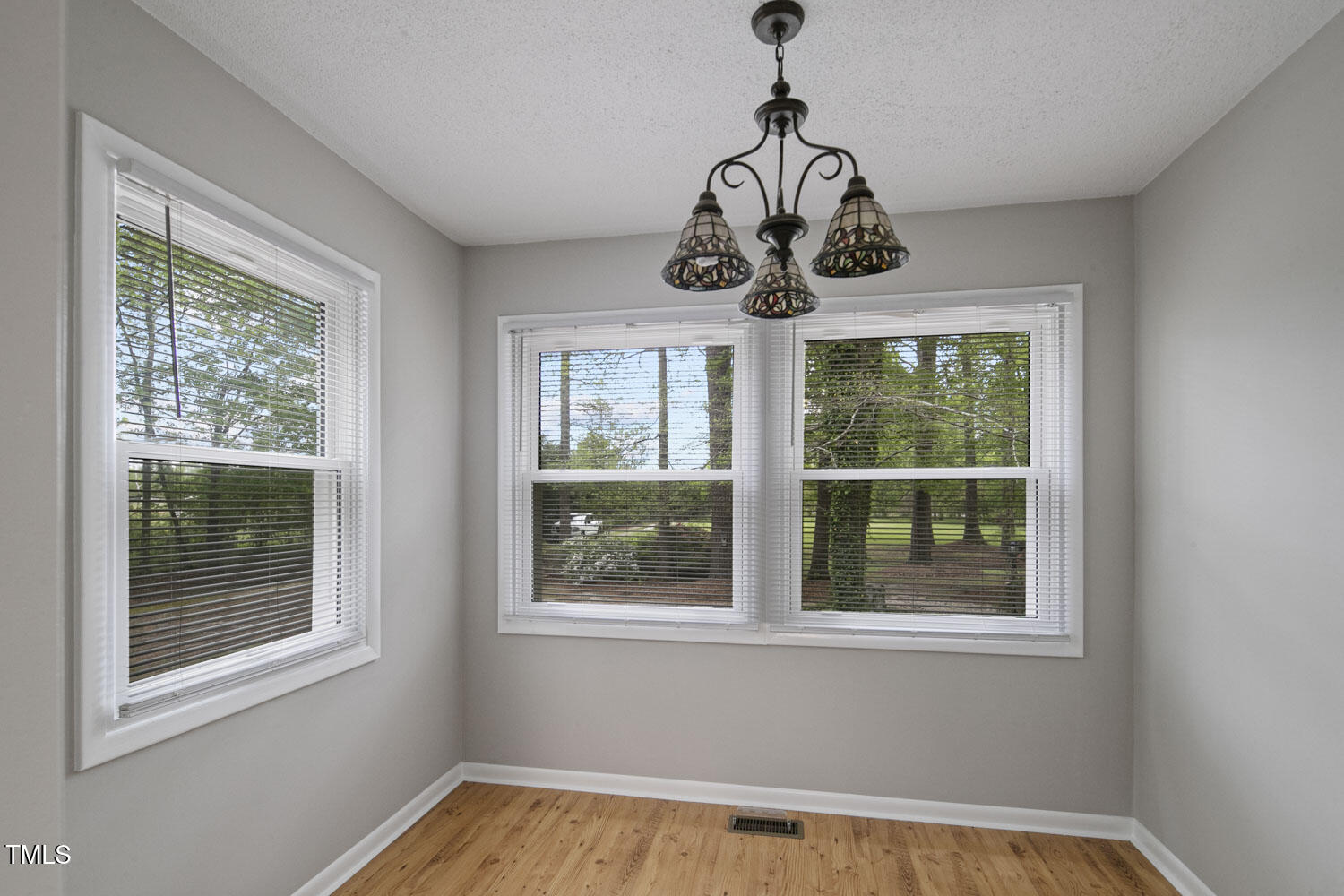 952 Glover Road Dunn, NC 28334 - Photo 12 of 31 a view of a bedroom with windows and ceiling fan