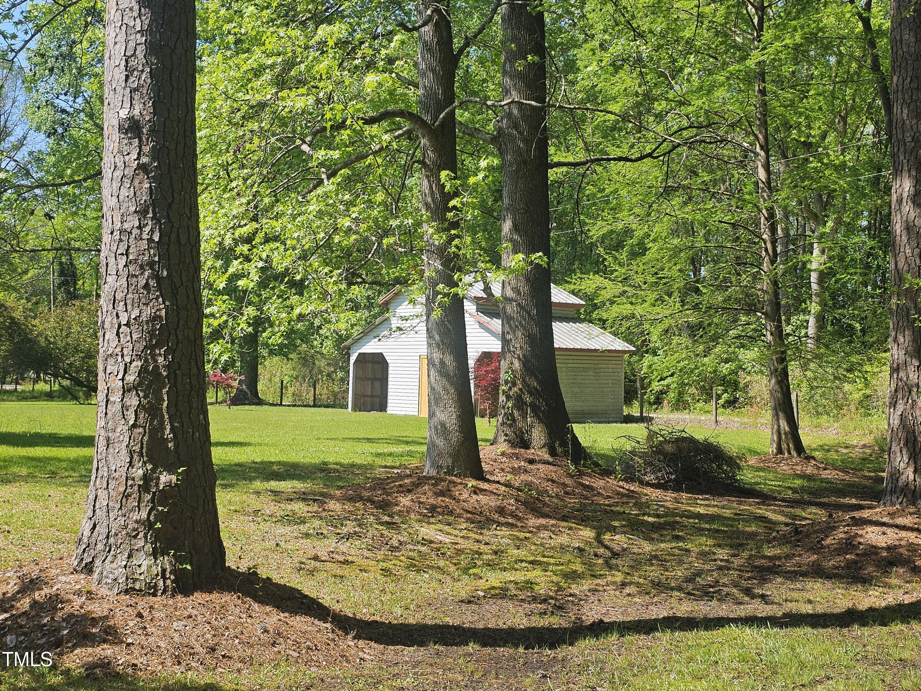 952 Glover Road Dunn, NC 28334 - Photo 2 of 31 a view of a garden with a tree