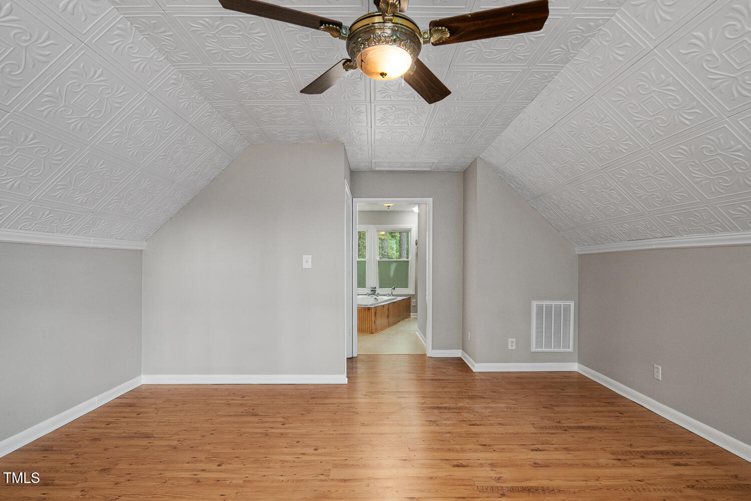 952 Glover Road Dunn, NC 28334 - Photo 22 of 31 a view of empty room with wooden floor and fan