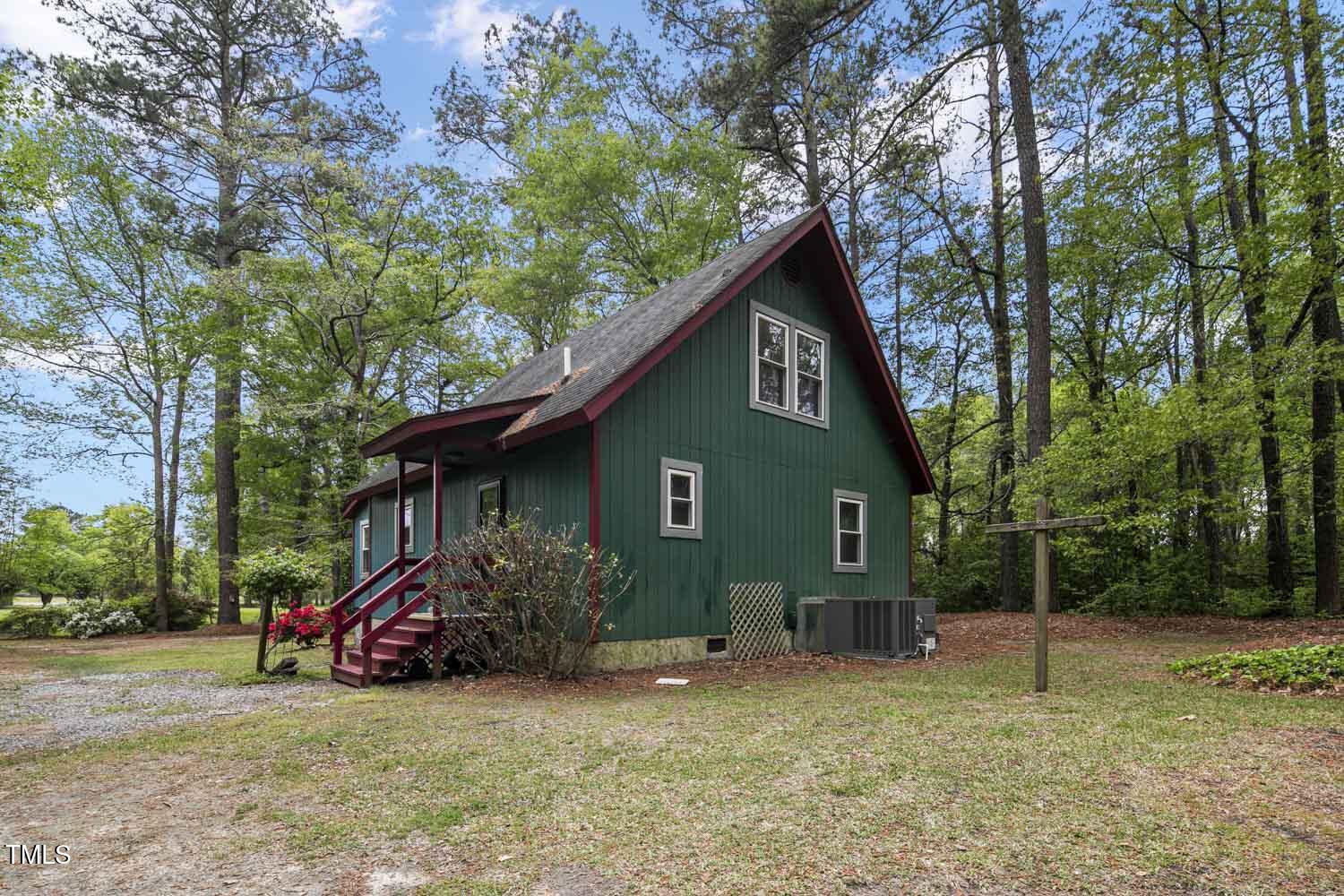952 Glover Road Dunn, NC 28334 - Photo 28 of 31 a view of a house with a yard and large trees