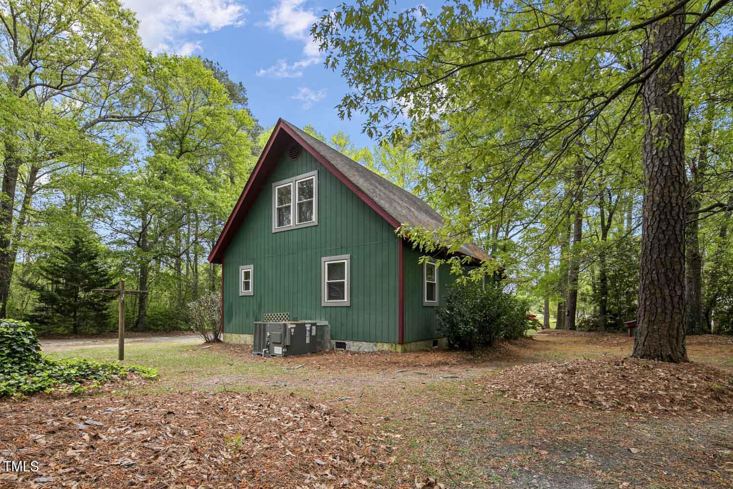 952 Glover Road Dunn, NC 28334 - Photo 29 of 31 a view of a house with a tree and plants
