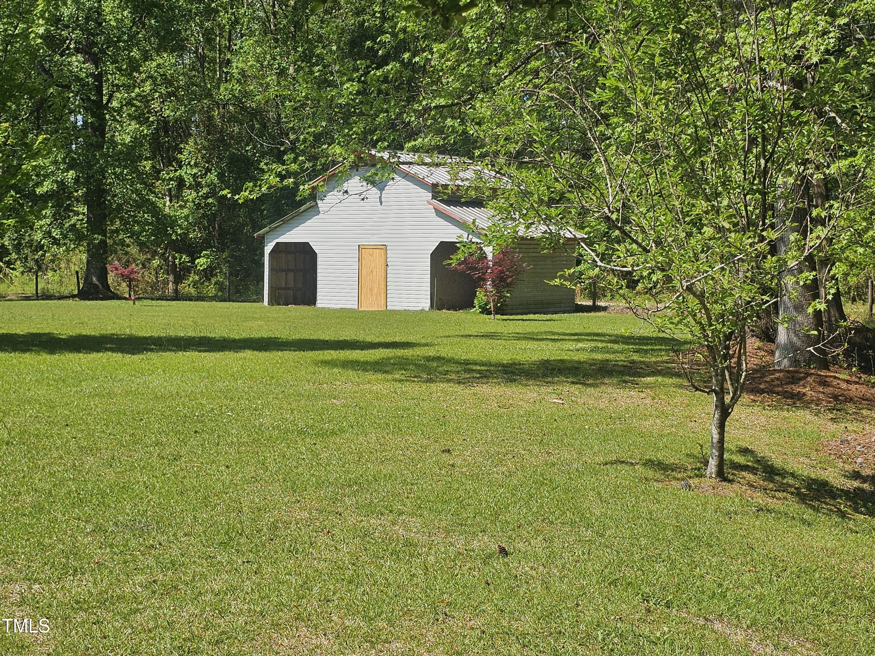 952 Glover Road Dunn, NC 28334 - Photo 5 of 31 a front view of a house with a yard