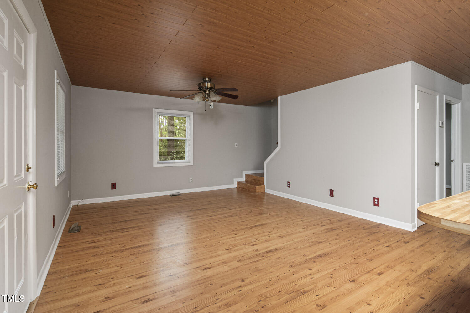 952 Glover Road Dunn, NC 28334 - Photo 8 of 31 a view of an empty room with wooden floor and a window