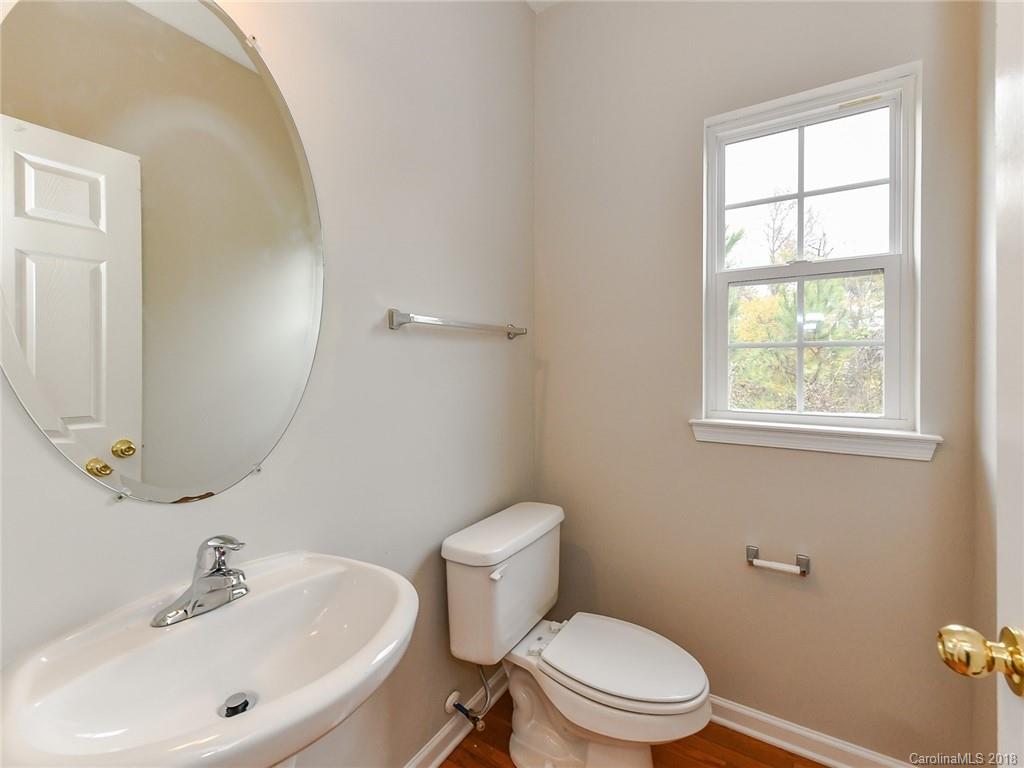 1965 Faison Avenue Fort Mill, SC 29708 - Photo 22 of 36 a white toilet sitting next to a bathroom sink