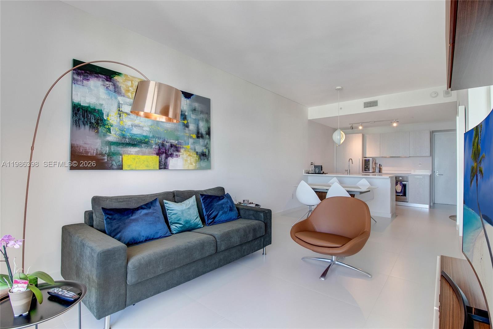 501 Northeast 31st Street, Unit 1502 Miami, FL 33137 - Photo 3 of 12 a living room with furniture and a chandelier