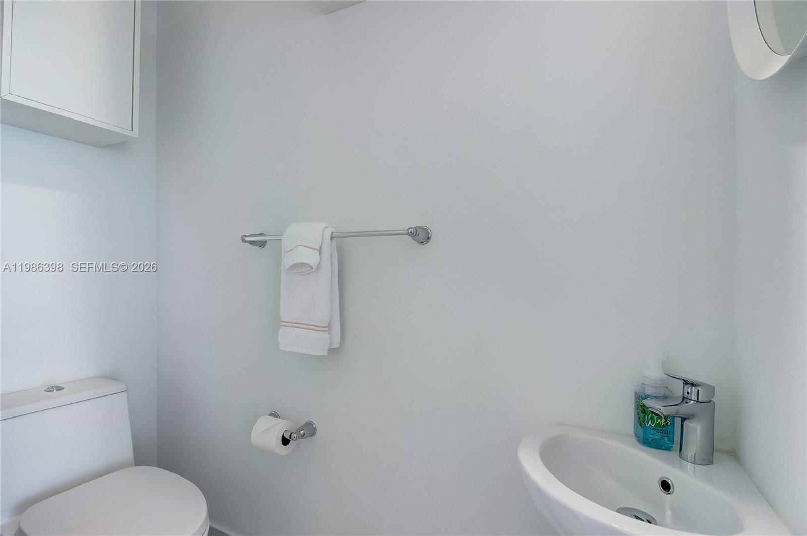 501 Northeast 31st Street, Unit 1502 Miami, FL 33137 - Photo 10 of 12 a bathroom with a sink a toilet and shower