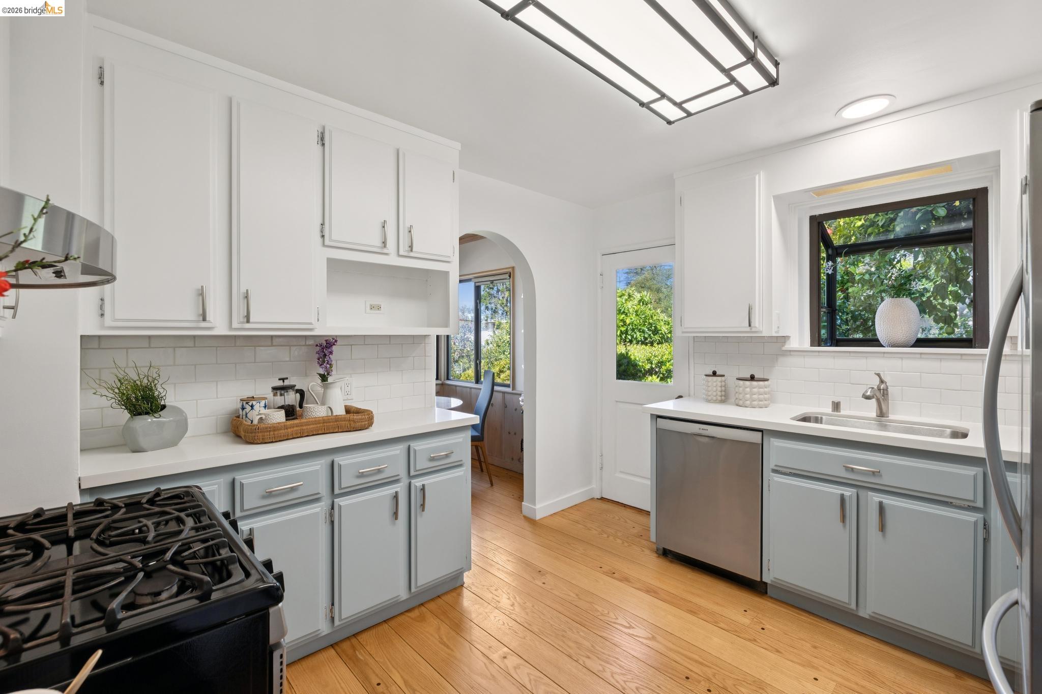 37 Kenyon Avenue Kensington, CA 94708 - Photo 18 of 60 a kitchen with stainless steel appliances a sink a stove and wooden floors