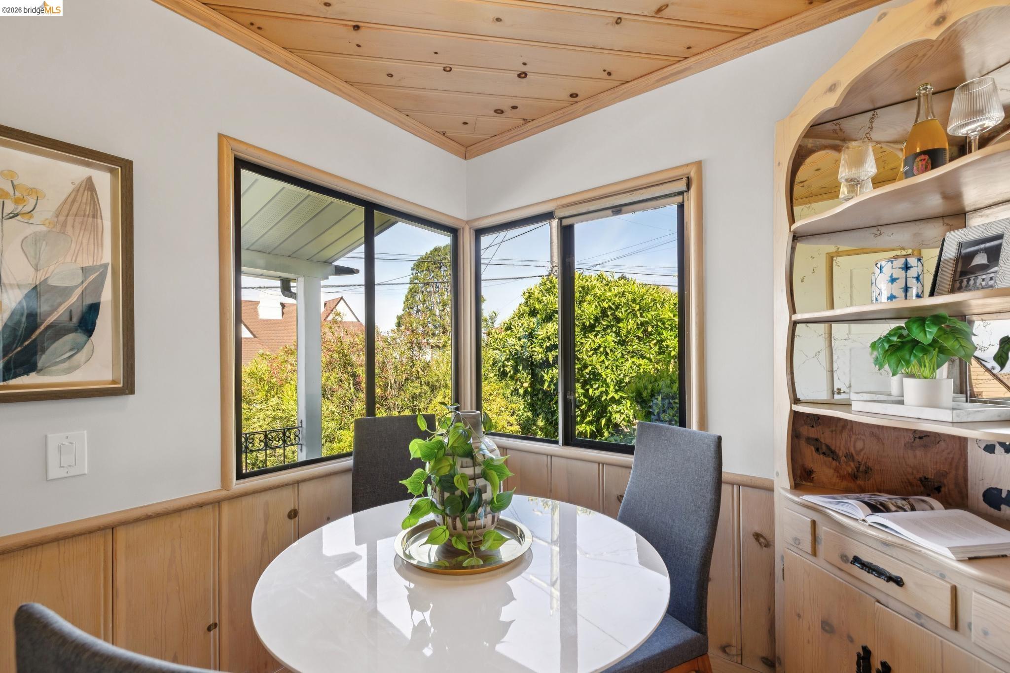 37 Kenyon Avenue Kensington, CA 94708 - Photo 22 of 60 a dining room with furniture a flat screen tv and a large window