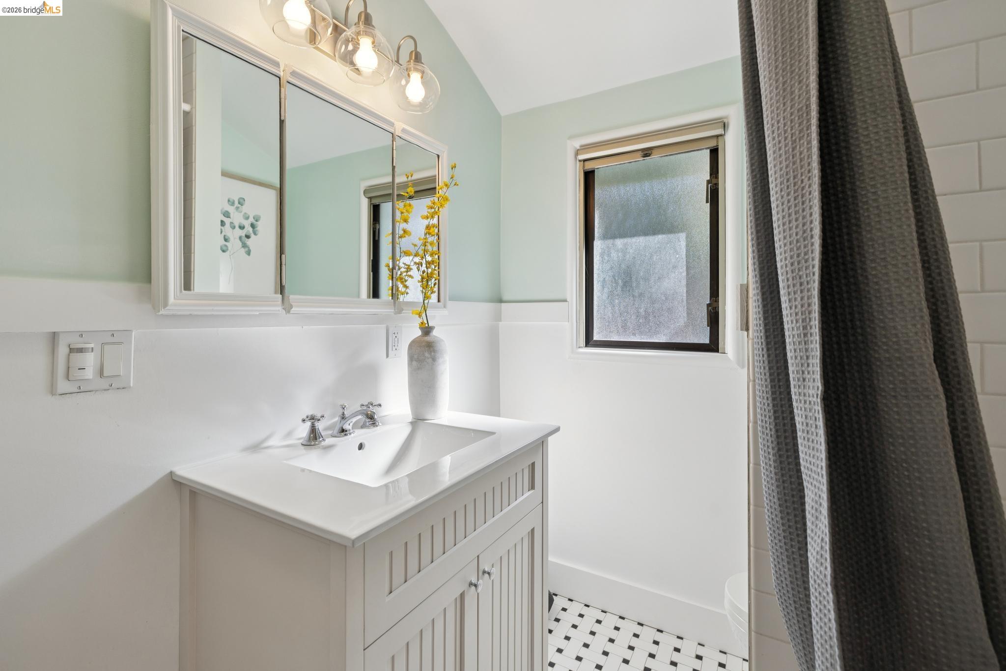 37 Kenyon Avenue Kensington, CA 94708 - Photo 36 of 60 a bathroom with a sink vanity and a mirror