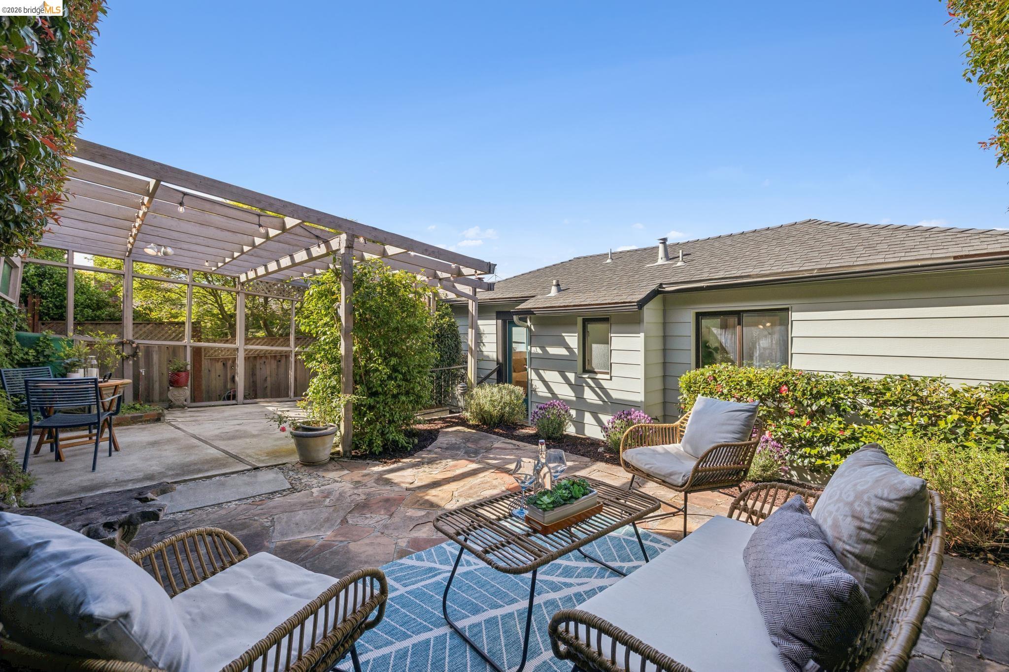 37 Kenyon Avenue Kensington, CA 94708 - Photo 46 of 60 a view of a patio with couches table and chairs under an umbrella with a fire pit
